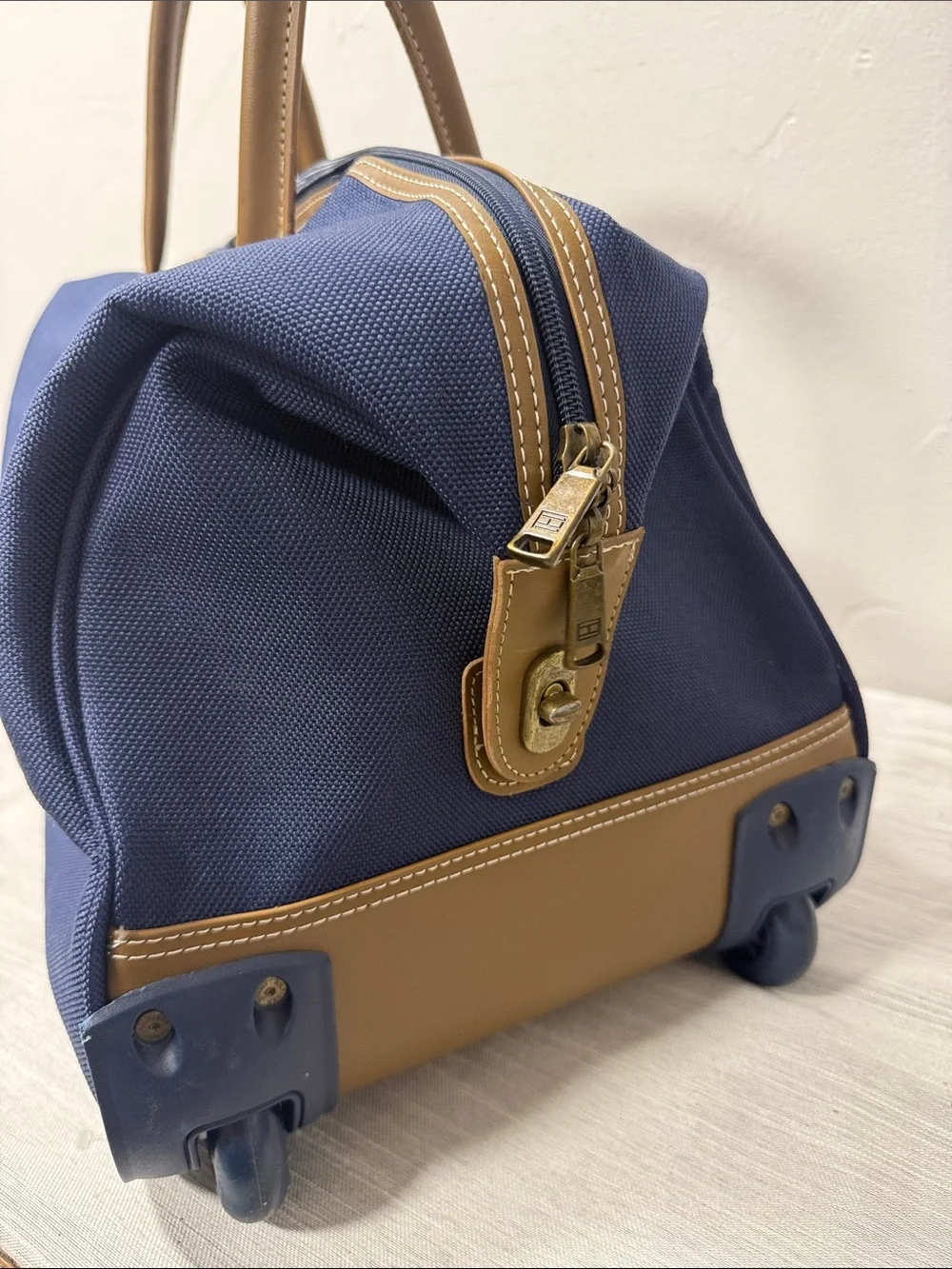Tommy Hilfiger Navy rolling Duffel with Red & White Center Stripe  carry on